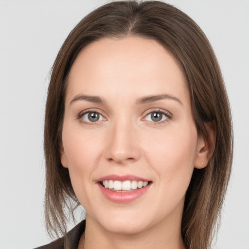 Joyful white young-adult female with long  brown hair and grey eyes