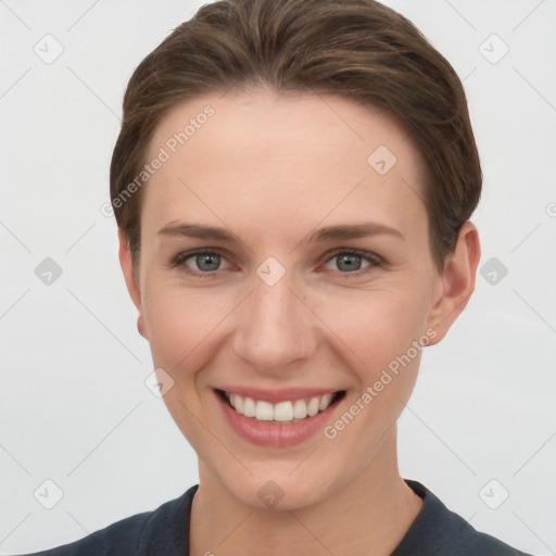 Joyful white young-adult female with short  brown hair and grey eyes