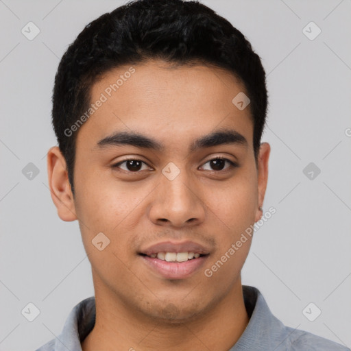 Joyful latino young-adult male with short  black hair and brown eyes