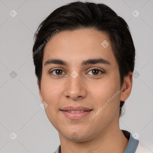 Joyful white young-adult male with short  black hair and brown eyes