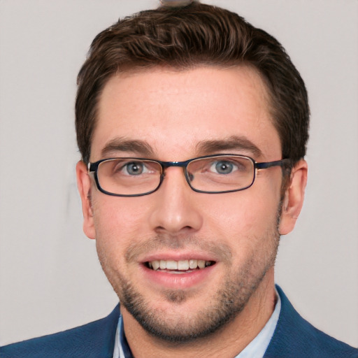 Joyful white young-adult male with short  brown hair and blue eyes