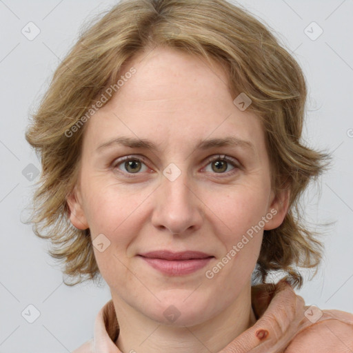 Joyful white adult female with medium  brown hair and blue eyes