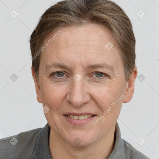 Joyful white adult female with short  brown hair and grey eyes