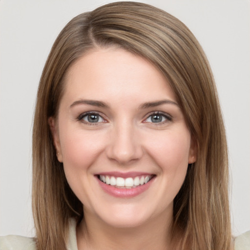 Joyful white young-adult female with long  brown hair and grey eyes