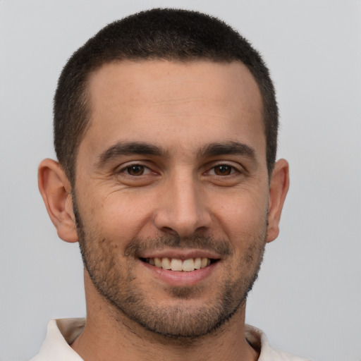 Joyful white young-adult male with short  brown hair and brown eyes