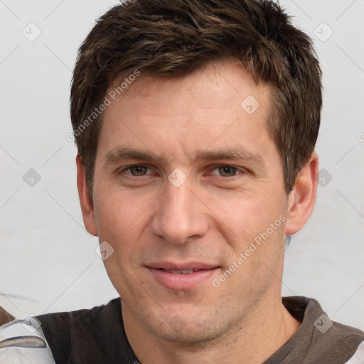 Joyful white adult male with short  brown hair and grey eyes