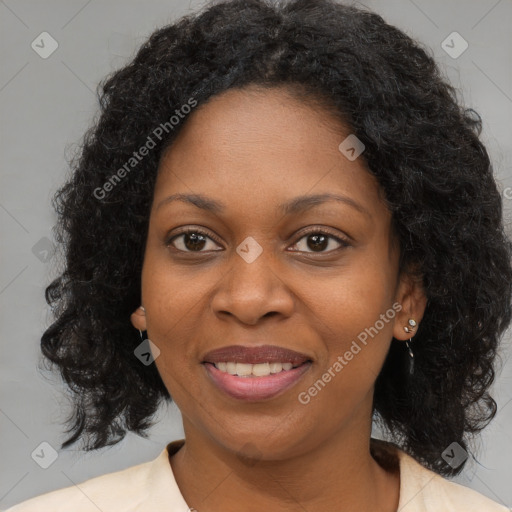 Joyful black adult female with medium  brown hair and brown eyes