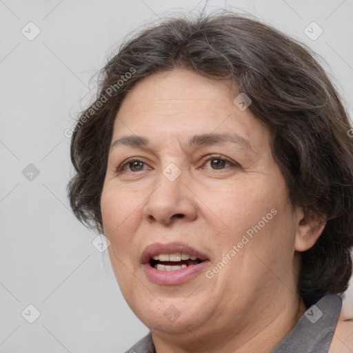 Joyful white adult female with medium  brown hair and brown eyes