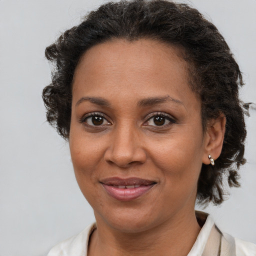 Joyful black adult female with short  brown hair and brown eyes