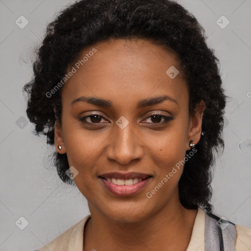 Joyful black young-adult female with long  black hair and brown eyes