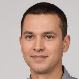 Joyful white young-adult male with short  brown hair and brown eyes