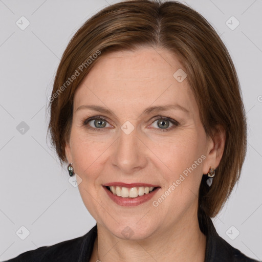 Joyful white adult female with medium  brown hair and grey eyes