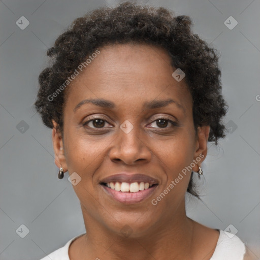 Joyful black young-adult female with short  brown hair and brown eyes