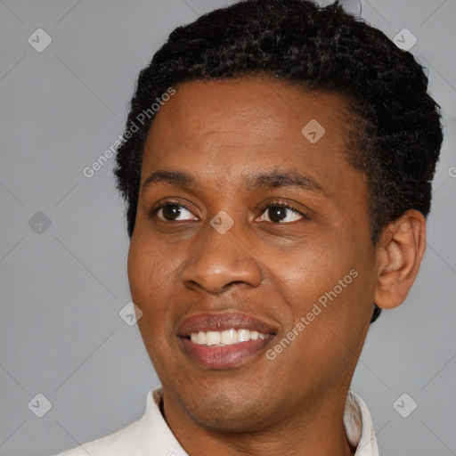 Joyful black young-adult male with short  black hair and brown eyes