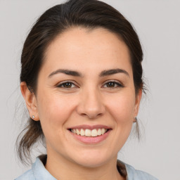 Joyful white young-adult female with medium  brown hair and brown eyes