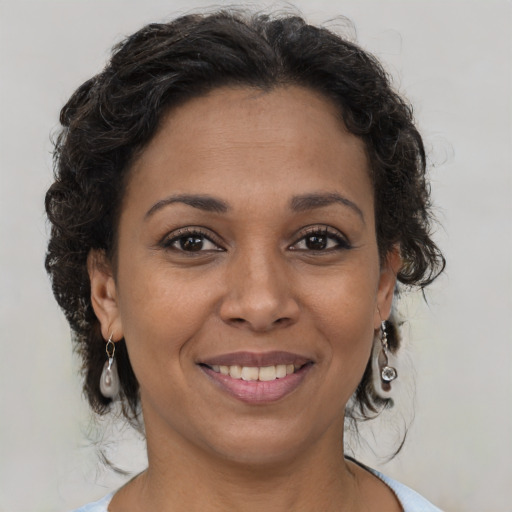 Joyful latino young-adult female with medium  brown hair and brown eyes
