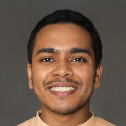 Joyful latino young-adult male with short  black hair and brown eyes