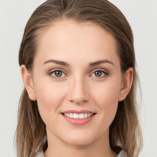 Joyful white young-adult female with long  brown hair and grey eyes