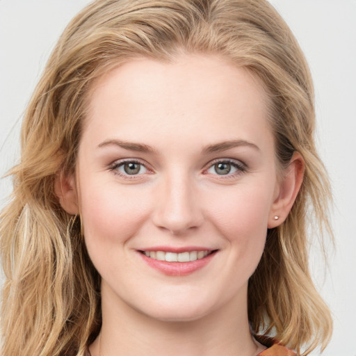 Joyful white young-adult female with long  brown hair and blue eyes