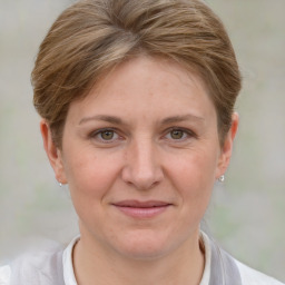 Joyful white adult female with short  brown hair and grey eyes