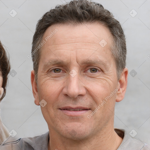 Joyful white adult male with short  brown hair and brown eyes