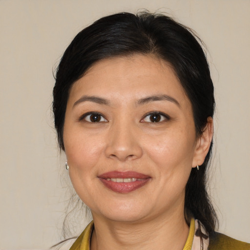 Joyful asian adult female with medium  brown hair and brown eyes