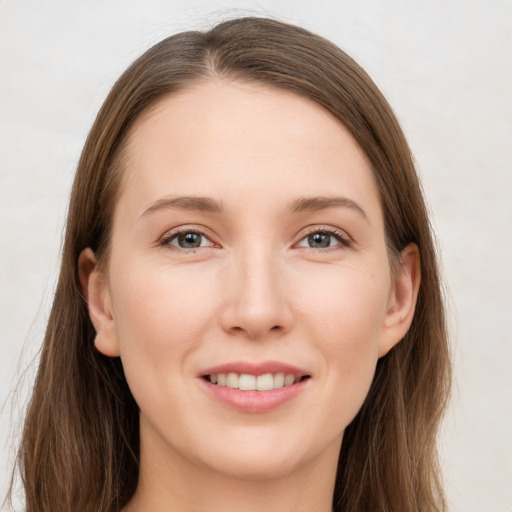 Joyful white young-adult female with long  brown hair and grey eyes