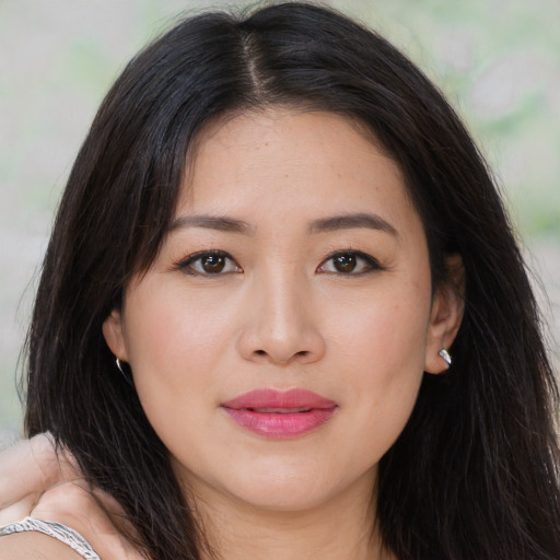 Joyful asian young-adult female with long  brown hair and brown eyes