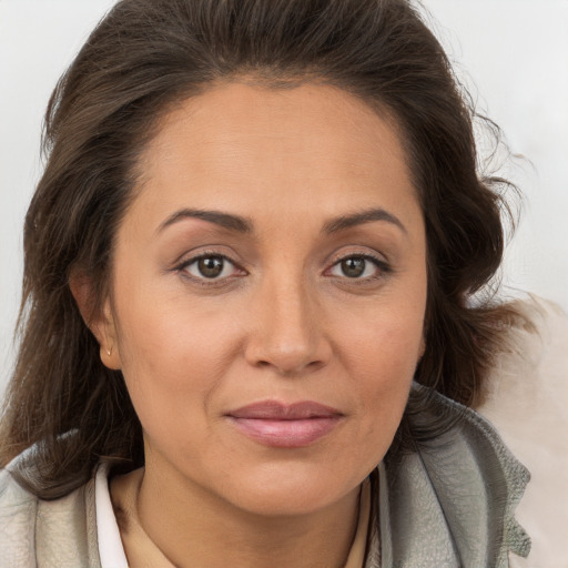 Joyful white adult female with long  brown hair and brown eyes