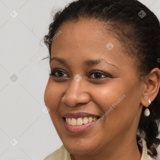 Joyful black young-adult female with medium  brown hair and brown eyes