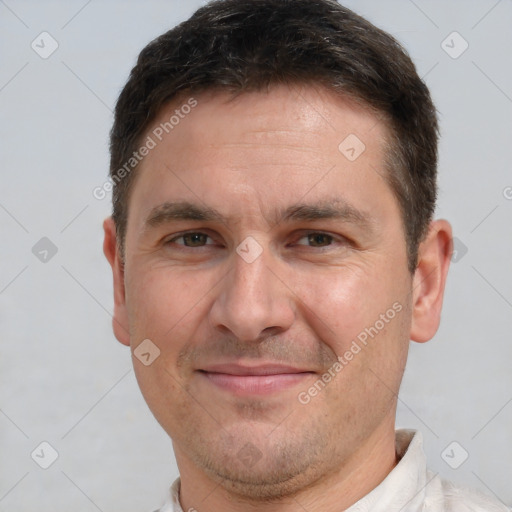 Joyful white adult male with short  brown hair and brown eyes