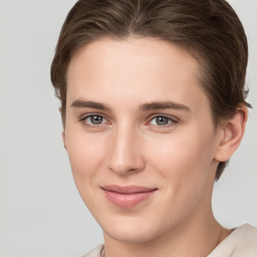 Joyful white young-adult female with short  brown hair and grey eyes