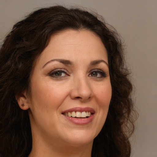 Joyful white adult female with long  brown hair and brown eyes