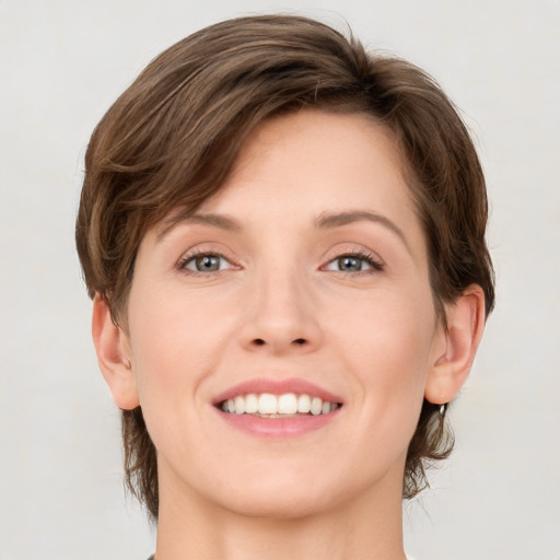 Joyful white young-adult female with medium  brown hair and grey eyes