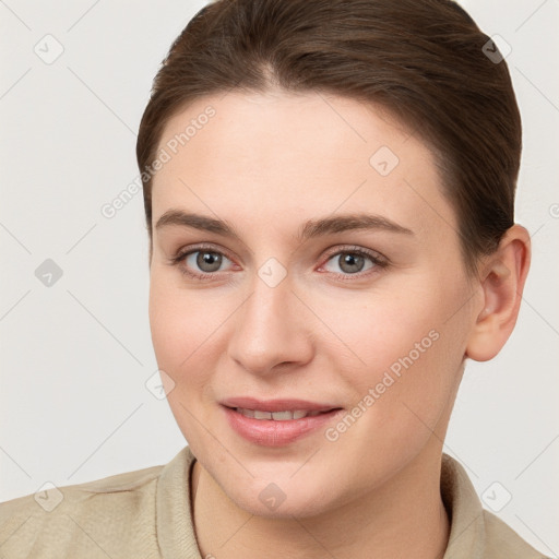 Joyful white young-adult female with short  brown hair and grey eyes