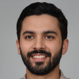 Joyful latino young-adult male with short  black hair and brown eyes