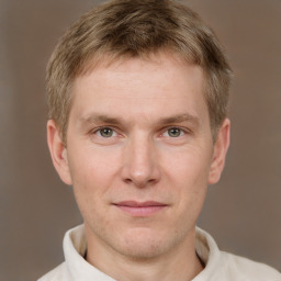 Joyful white adult male with short  brown hair and brown eyes
