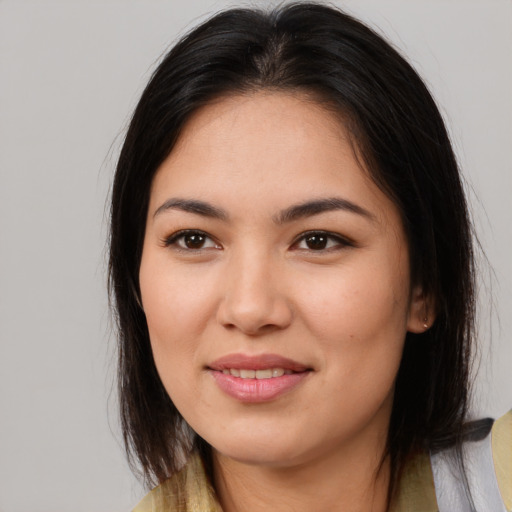 Joyful asian young-adult female with medium  brown hair and brown eyes