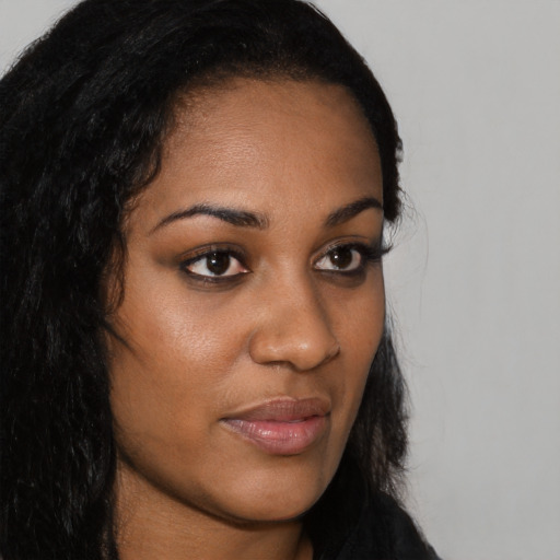 Neutral black young-adult female with long  brown hair and brown eyes