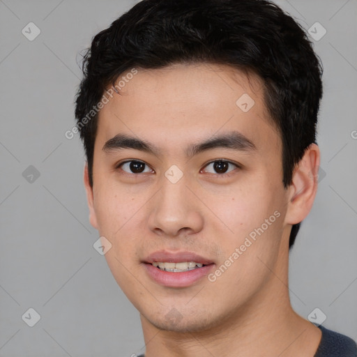 Joyful asian young-adult male with short  black hair and brown eyes