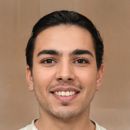 Joyful white young-adult male with short  brown hair and brown eyes