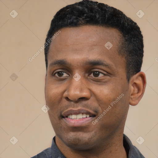 Joyful black young-adult male with short  black hair and brown eyes