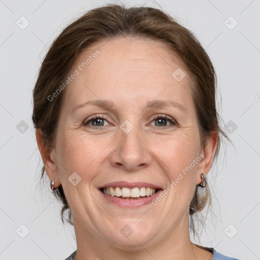 Joyful white adult female with medium  brown hair and blue eyes