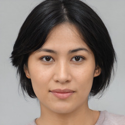 Joyful asian young-adult female with medium  black hair and brown eyes