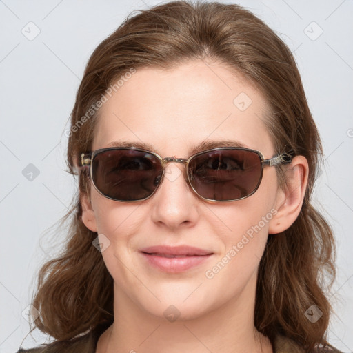 Joyful white young-adult female with long  brown hair and blue eyes