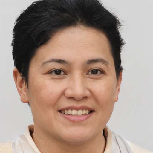 Joyful asian adult female with short  brown hair and brown eyes