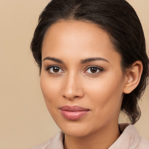 Joyful latino young-adult female with medium  brown hair and brown eyes