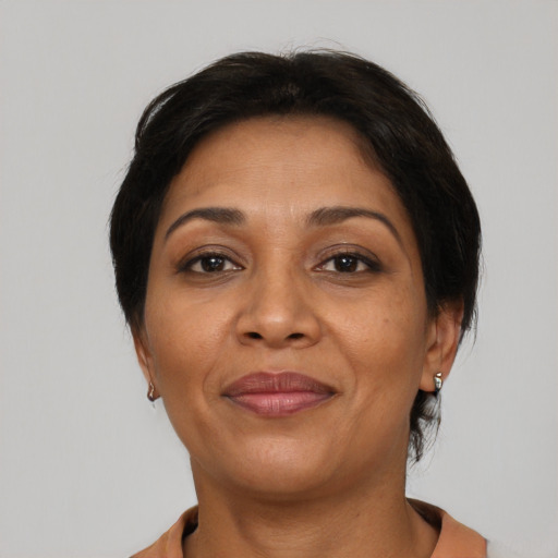Joyful latino adult female with short  brown hair and brown eyes