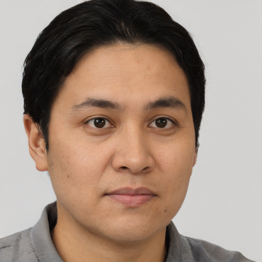 Joyful asian young-adult male with short  brown hair and brown eyes