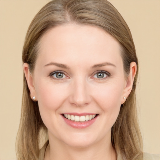 Joyful white young-adult female with long  brown hair and blue eyes